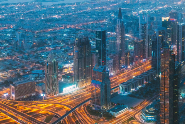 Aerial view of Dubai skyline and highways, representing the business and economic hub in 2025.